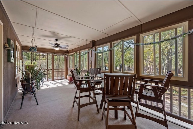 sunroom / solarium featuring ceiling fan