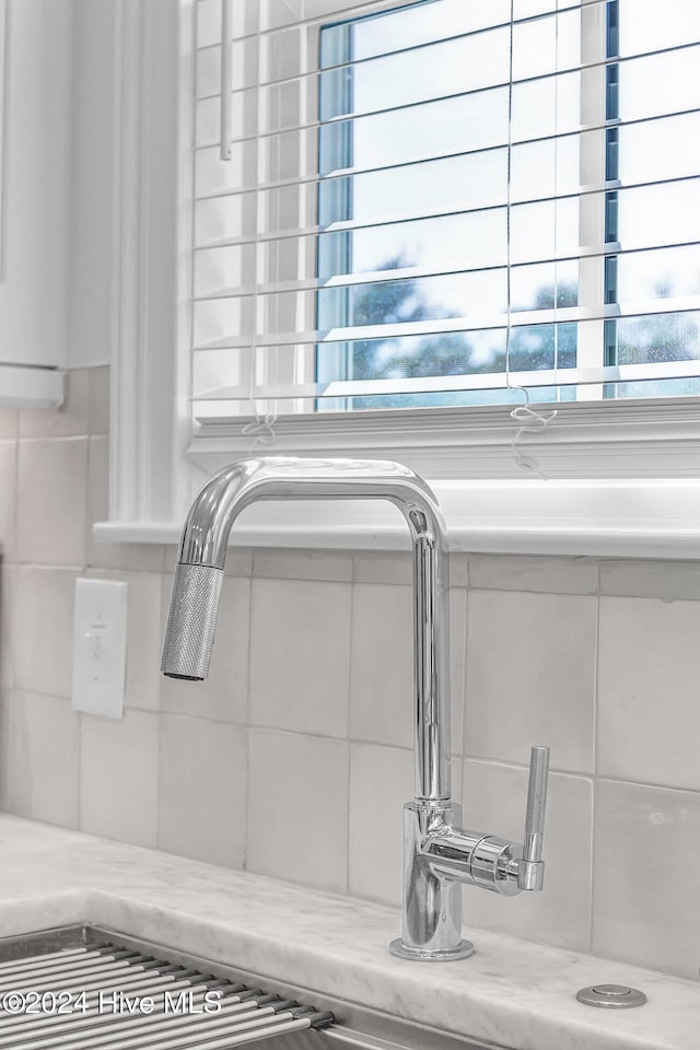 details featuring light stone countertops and sink