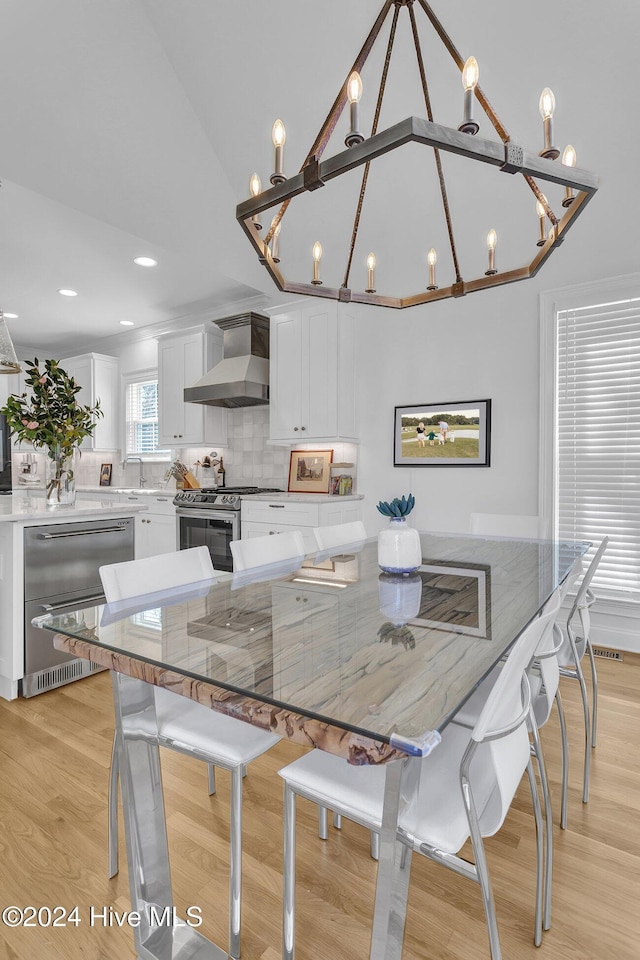 dining area featuring a chandelier and light wood-type flooring