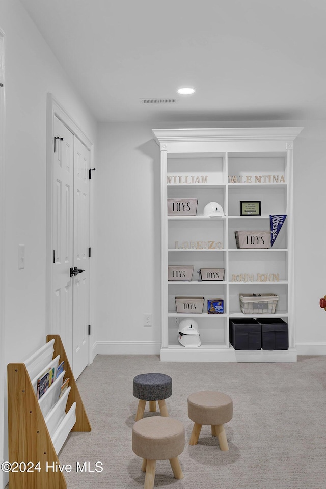 living area featuring light colored carpet