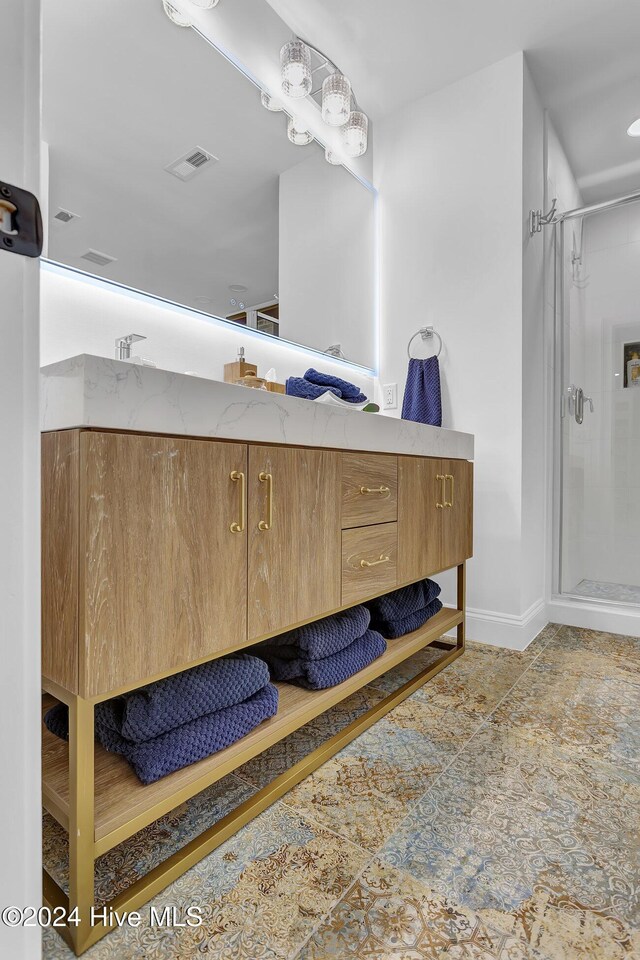 bathroom with a shower and vanity