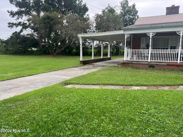 view of yard featuring a porch and a carport