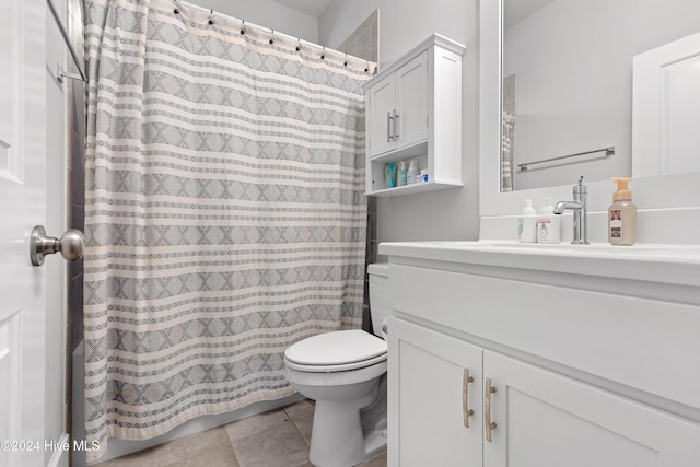 bathroom featuring tile patterned flooring, vanity, and toilet