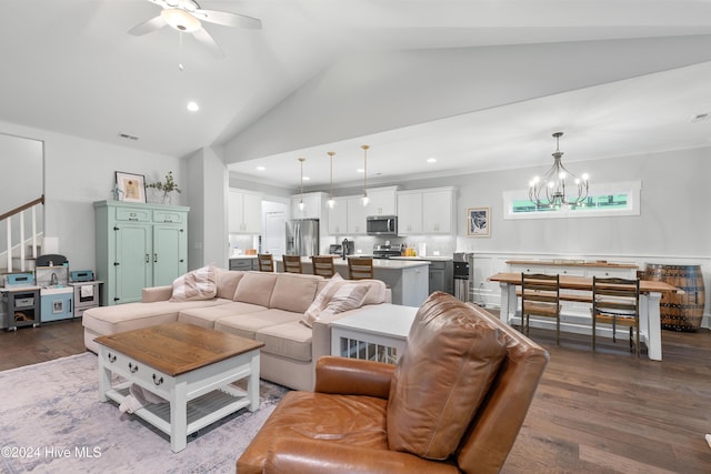 living room featuring vaulted ceiling, ceiling fan with notable chandelier, dark hardwood / wood-style floors, and ornamental molding