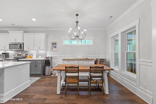 interior space featuring a notable chandelier, ornamental molding, and dark wood-type flooring