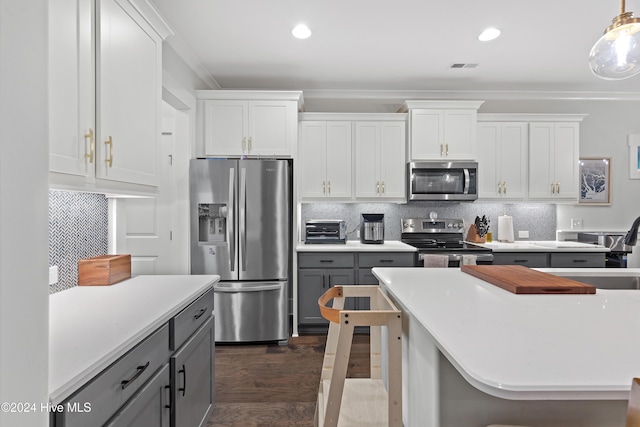 kitchen featuring white cabinets, pendant lighting, gray cabinets, and stainless steel appliances