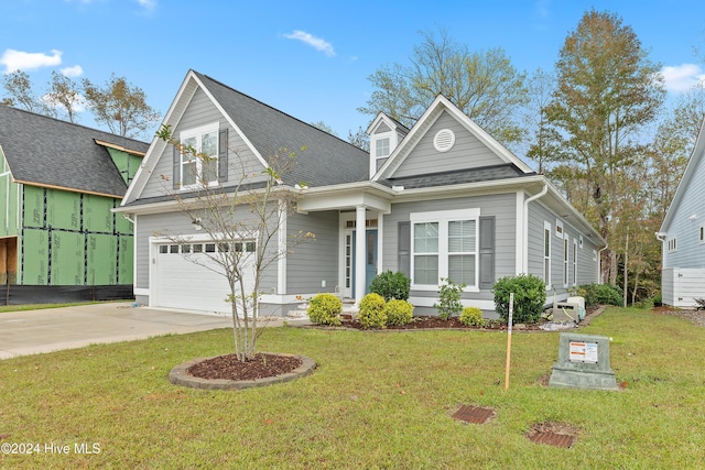 view of front of property featuring a garage and a front lawn