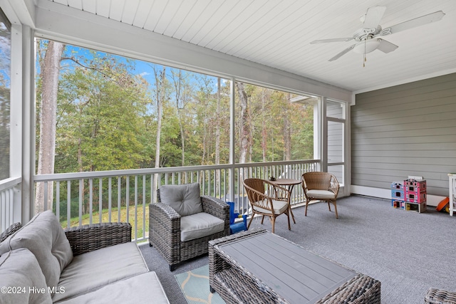 sunroom featuring ceiling fan