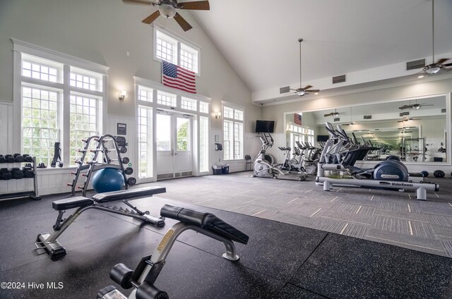 exercise room with high vaulted ceiling, ceiling fan, a wealth of natural light, and french doors