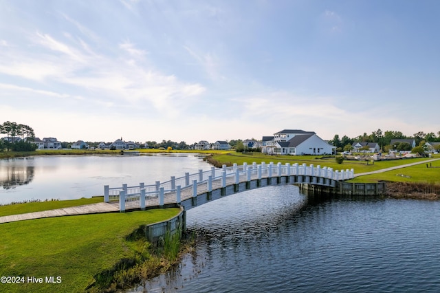 view of dock featuring a yard and a water view