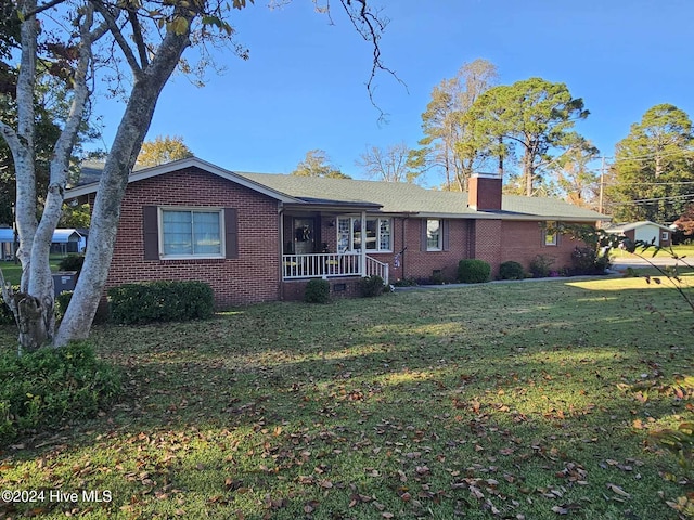 view of front of house with a front yard and a porch