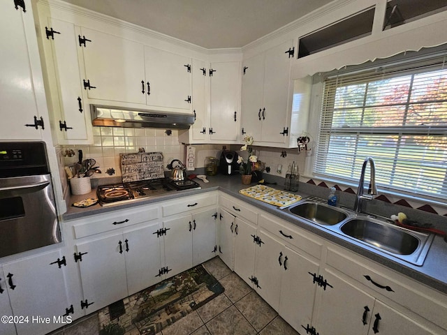 kitchen with stainless steel oven, range hood, and white cabinets