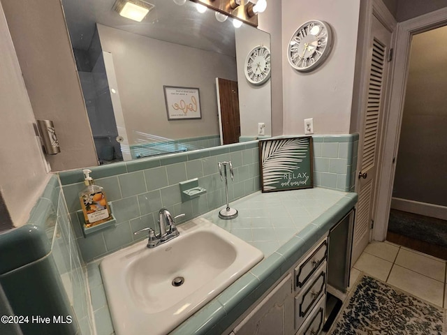 bathroom with tasteful backsplash, vanity, and tile patterned floors