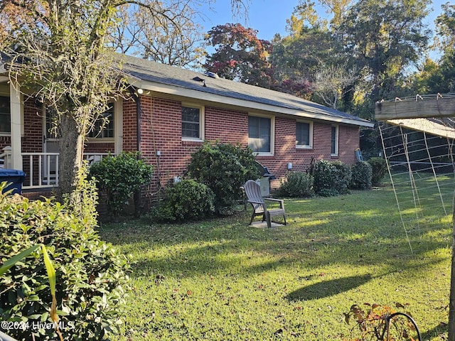 rear view of house featuring a lawn