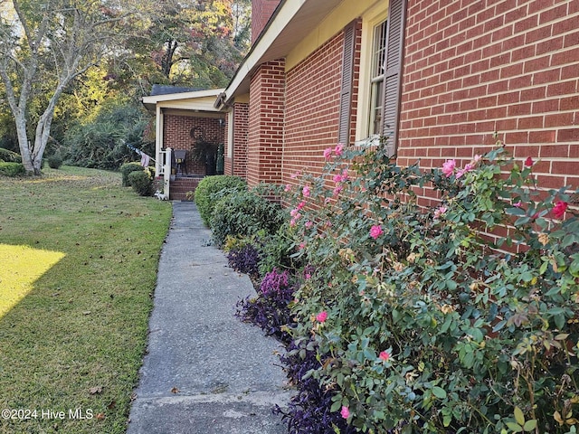 view of property exterior with a yard