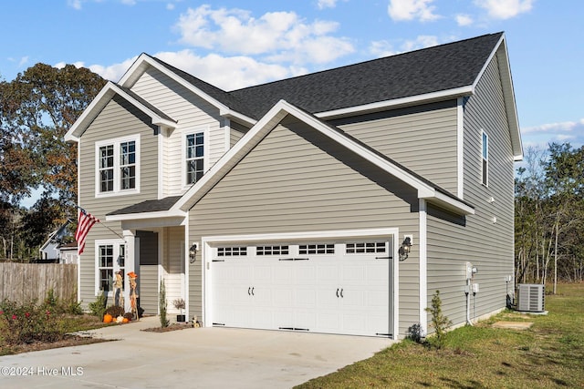 view of front of house featuring central AC and a garage