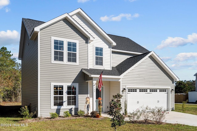 view of front of house with a garage and a front lawn