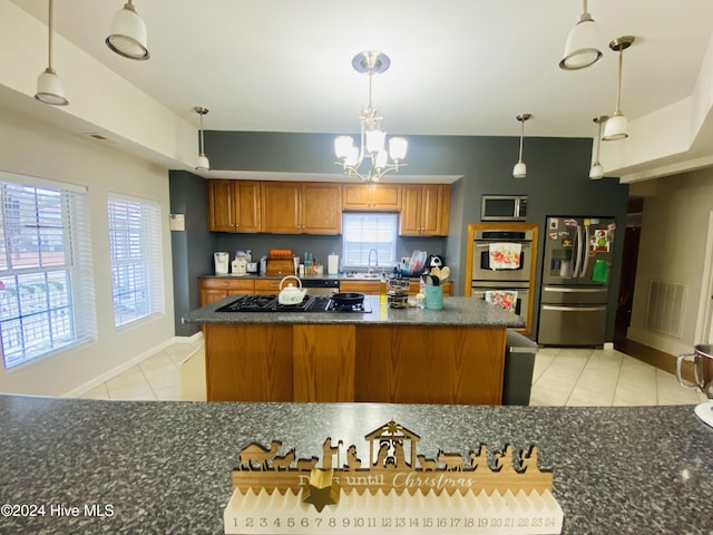 kitchen featuring sink, stainless steel appliances, a notable chandelier, pendant lighting, and light tile patterned floors