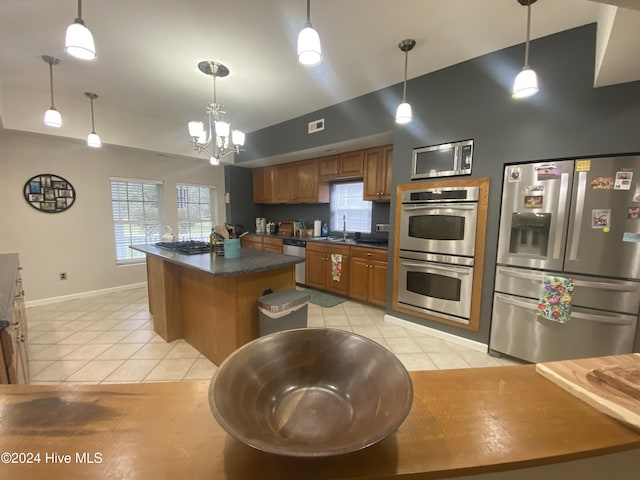 kitchen with pendant lighting, light tile patterned floors, and stainless steel appliances