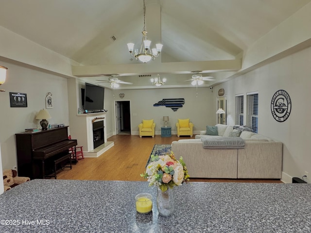 955 Mt Pisgah Rd SW, Supply, NC 28462 - living room with ceiling fan, a chandelier, a fireplace with raised hearth, wood finished floors, and baseboards