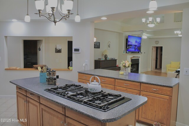 955 Mt Pisgah Rd SW, Supply, NC 28462 - kitchen with black gas stovetop, a kitchen island, a chandelier, open floor plan, and ceiling fan