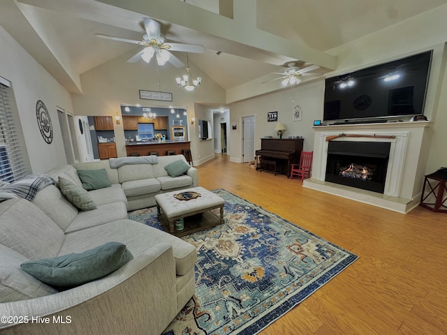 955 Mt Pisgah Rd SW, Supply, NC 28462 - living area featuring ceiling fan, light wood finished floors, a lit fireplace, and high vaulted ceiling