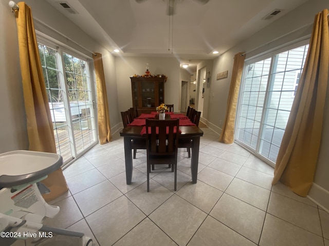 dining room with a wealth of natural light and light tile patterned floors