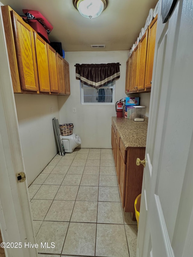 955 Mt Pisgah Rd SW, Supply, NC 28462 - laundry area featuring light tile patterned floors and cabinet space
