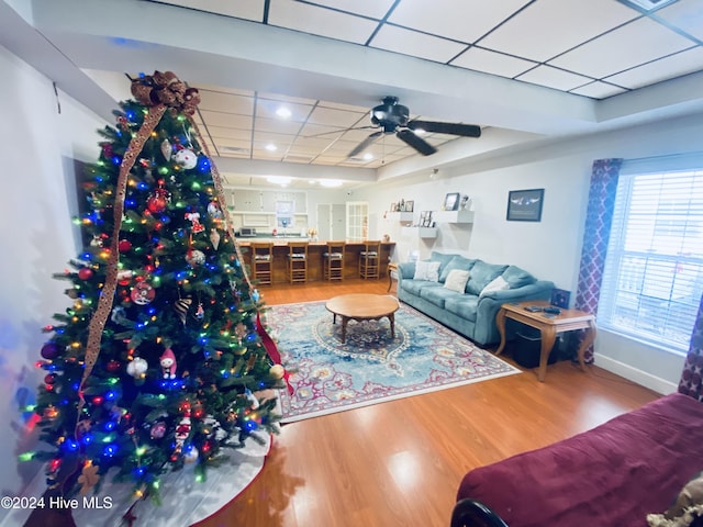 living room featuring hardwood / wood-style flooring and ceiling fan