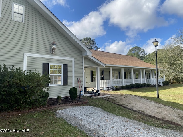 view of front of property with covered porch and a front yard