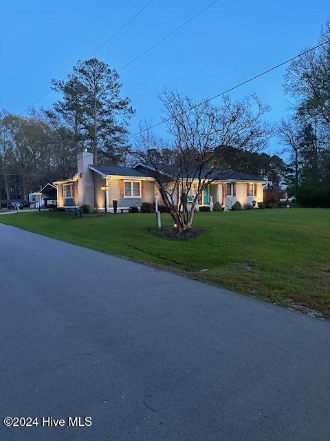 ranch-style house with a front lawn