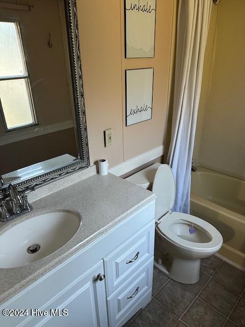 full bathroom featuring tile patterned floors, vanity, toilet, and shower / tub combo