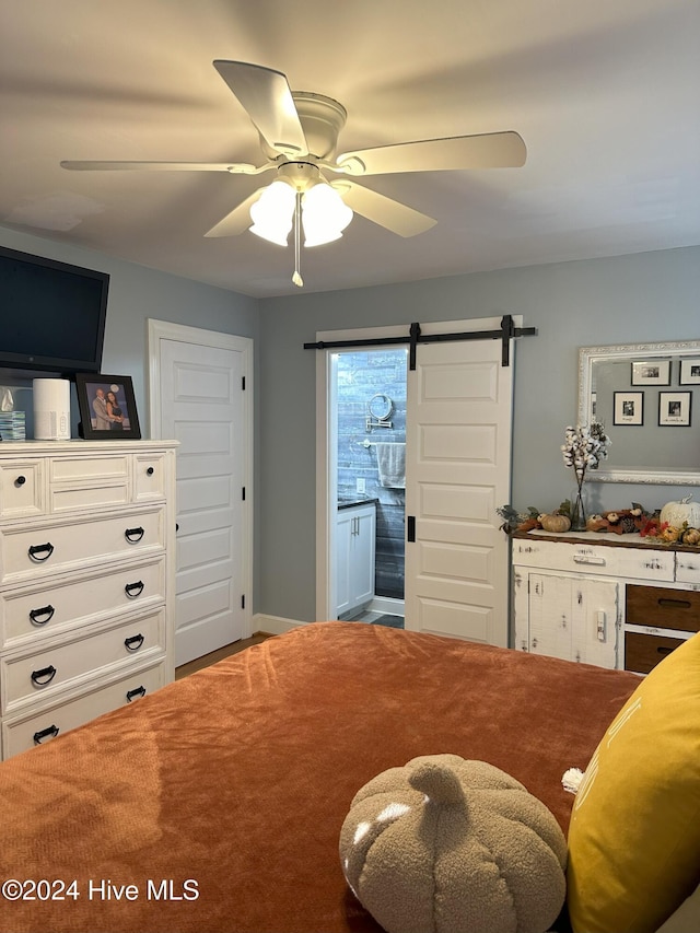 sitting room featuring carpet flooring, a barn door, and ceiling fan