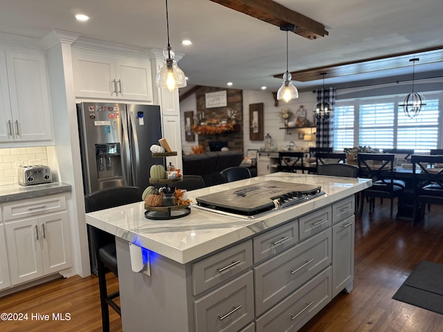 kitchen with white cabinetry, stainless steel appliances, dark wood-type flooring, tasteful backsplash, and decorative light fixtures