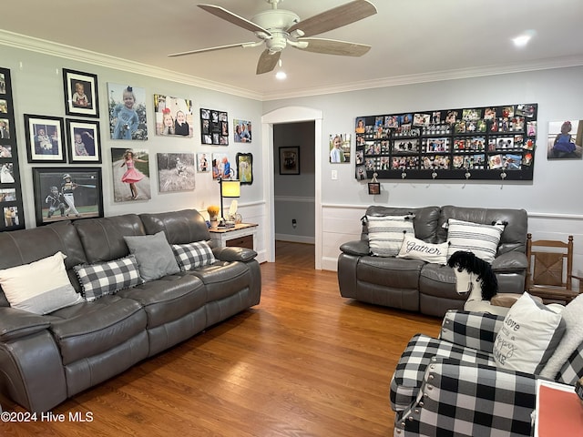 living room with crown molding, ceiling fan, and wood-type flooring