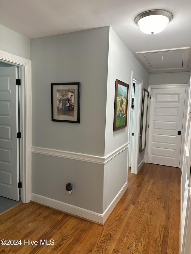 corridor with hardwood / wood-style flooring