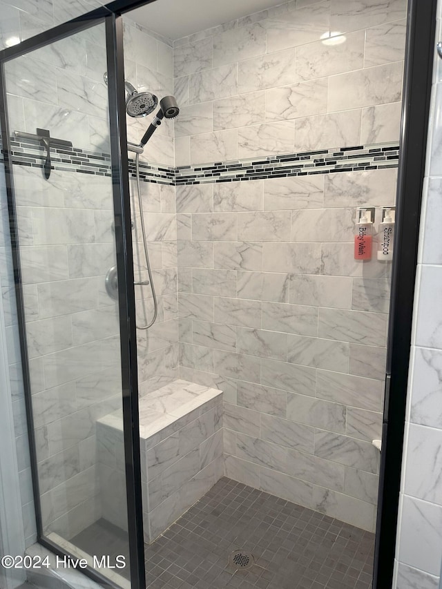 bathroom with a shower with shower door