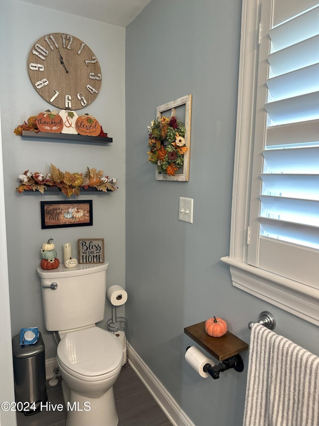 bathroom with radiator heating unit and toilet