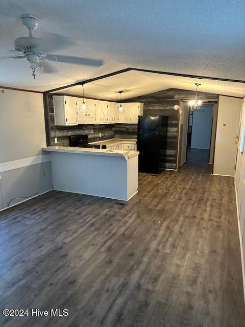 kitchen featuring dark wood-type flooring, black appliances, kitchen peninsula, decorative light fixtures, and white cabinetry