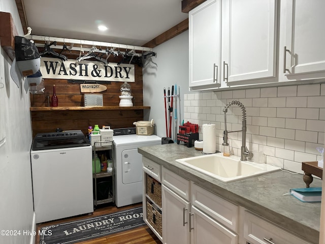 kitchen with dark hardwood / wood-style flooring, backsplash, sink, washing machine and dryer, and white cabinetry