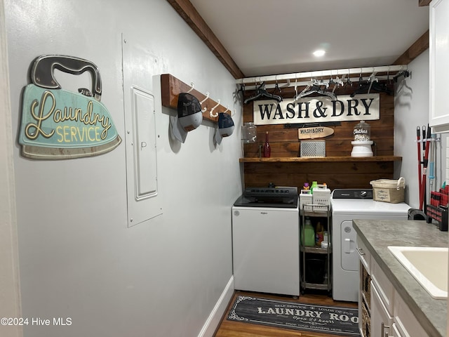 clothes washing area with cabinets, wood-type flooring, separate washer and dryer, and sink