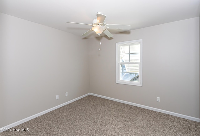 carpeted empty room featuring ceiling fan