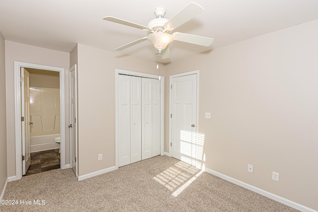 unfurnished bedroom with a closet, light carpet, ceiling fan, and ensuite bath