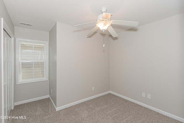 spare room with carpet flooring and ceiling fan