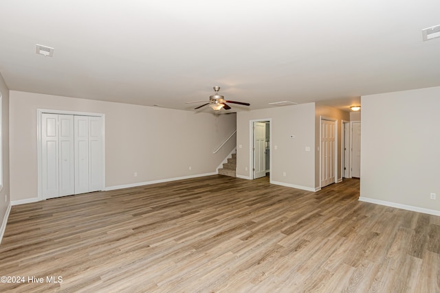 unfurnished living room featuring light hardwood / wood-style flooring and ceiling fan