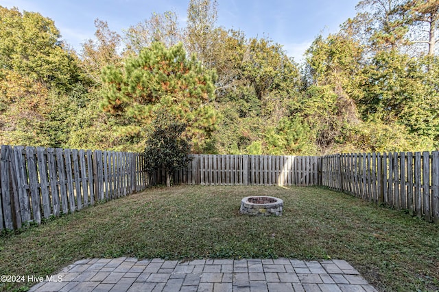 view of yard with a fire pit