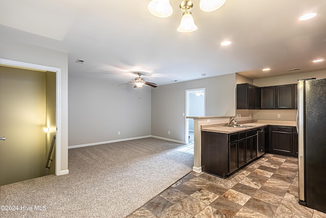 105 James Ave Unit A, Surf City, NC 28445 - kitchen with freestanding refrigerator, a sink, dark colored carpet, baseboards, and a ceiling fan