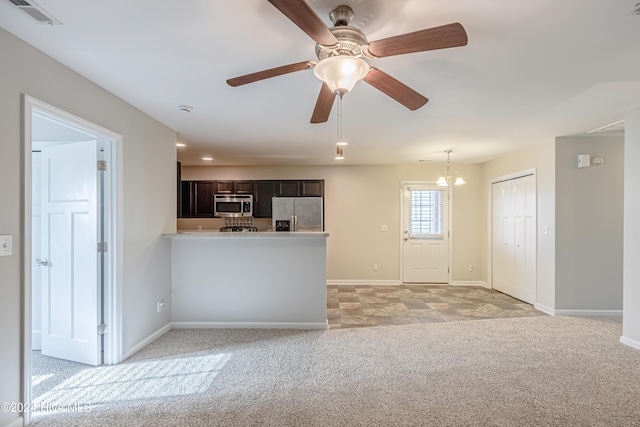 105 James Ave Unit A, Surf City, NC 28445 - kitchen with stainless steel appliances, light carpet, baseboards, light countertops, and a peninsula