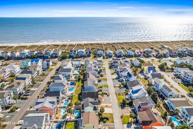 drone / aerial view with a water view and a beach view