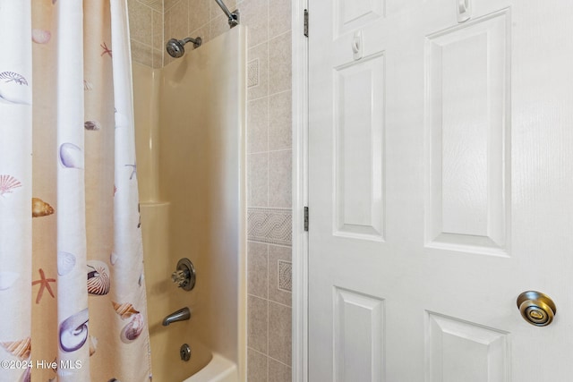 bathroom with shower / bath combination with curtain